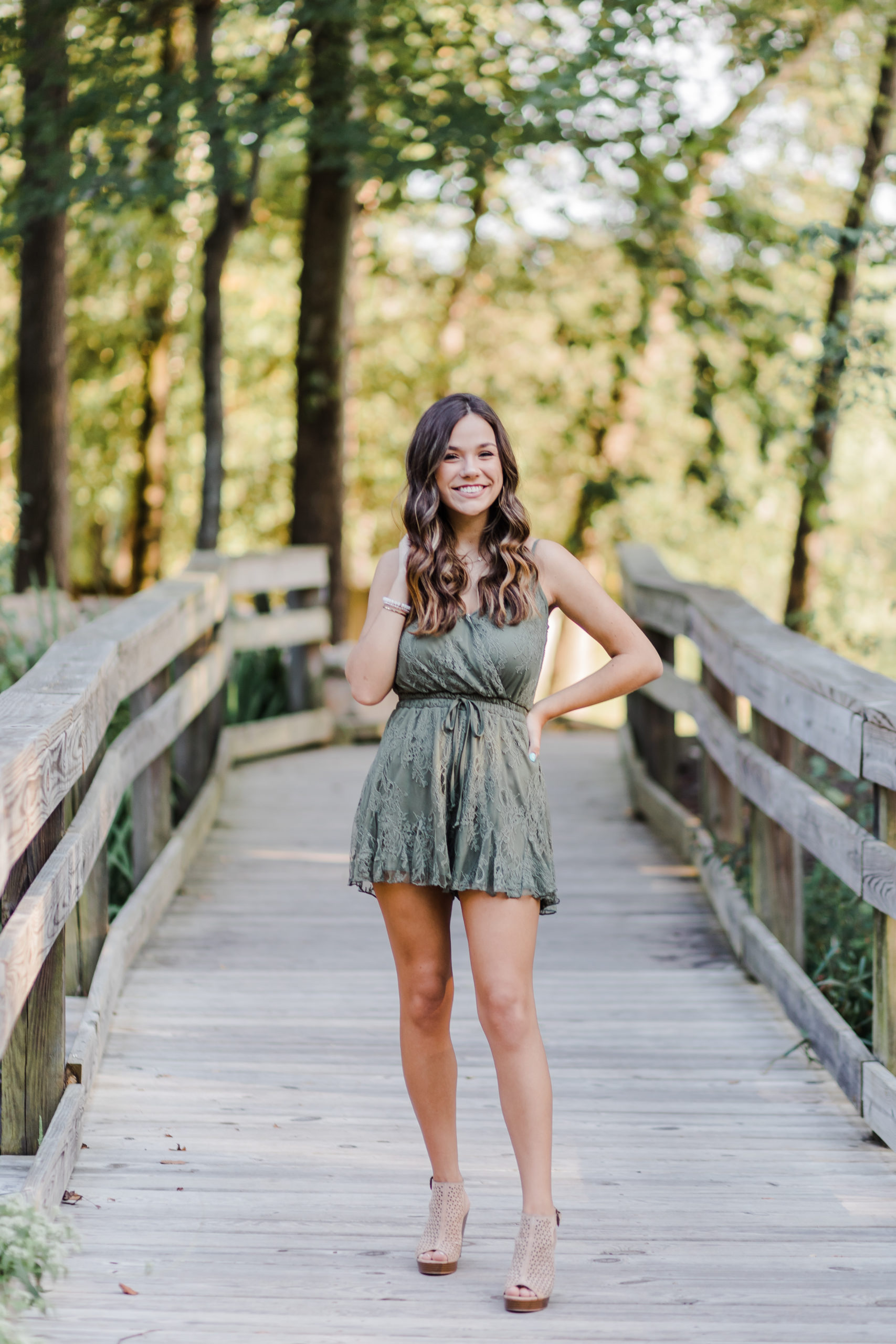 senior pictures by Augusta senior photographer with girl on a bridge in the woods