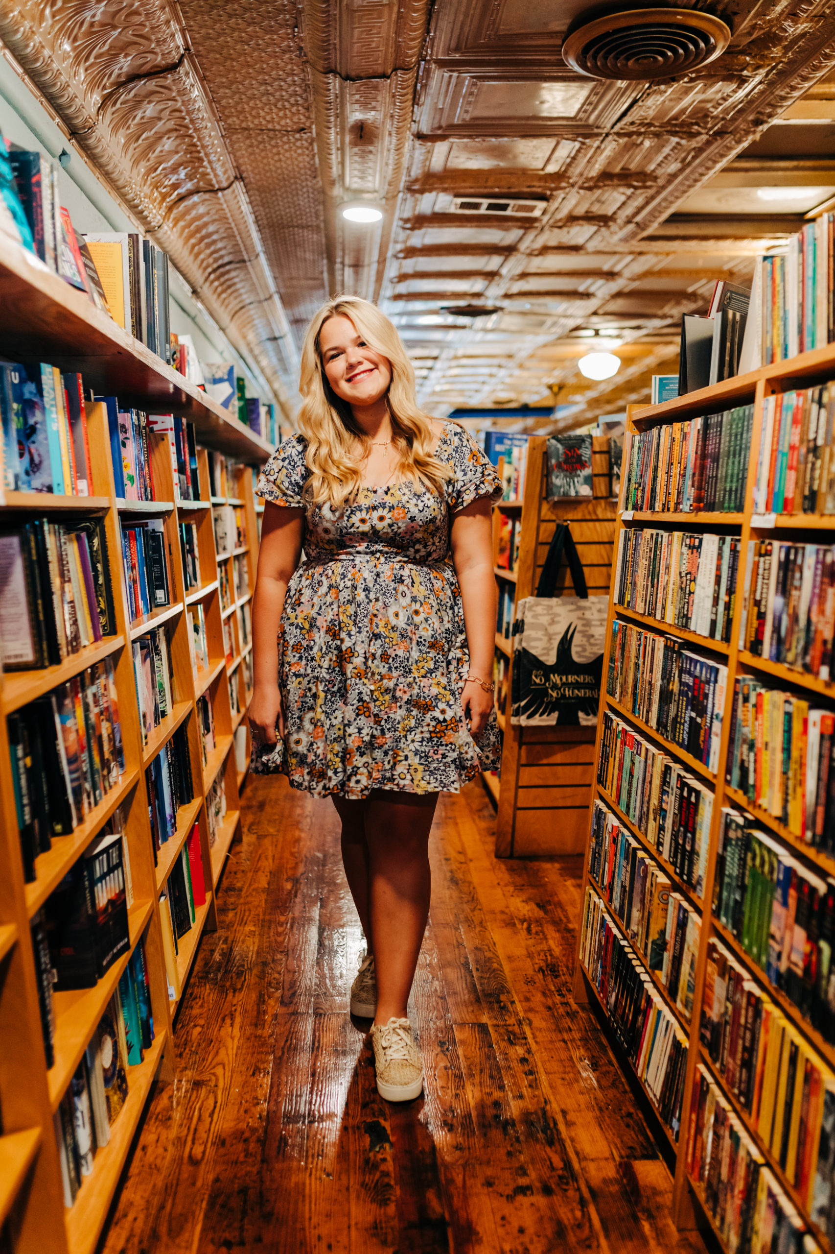 Augusta photographer captures high school senior walking through a book store for a Taylor Swift inspired senior photoshoot