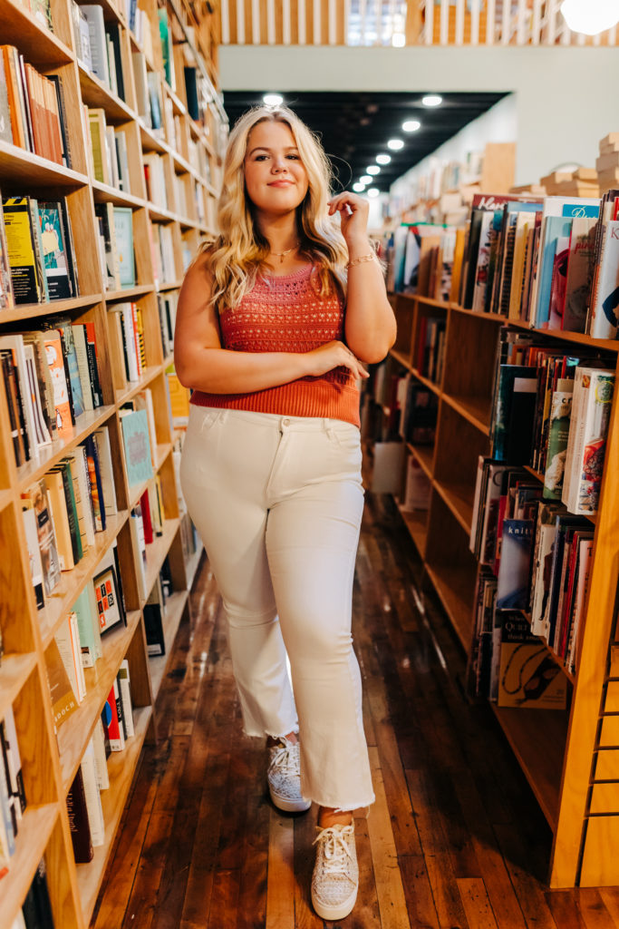 augusta photographer captures senior session in a book store with girl posing with books