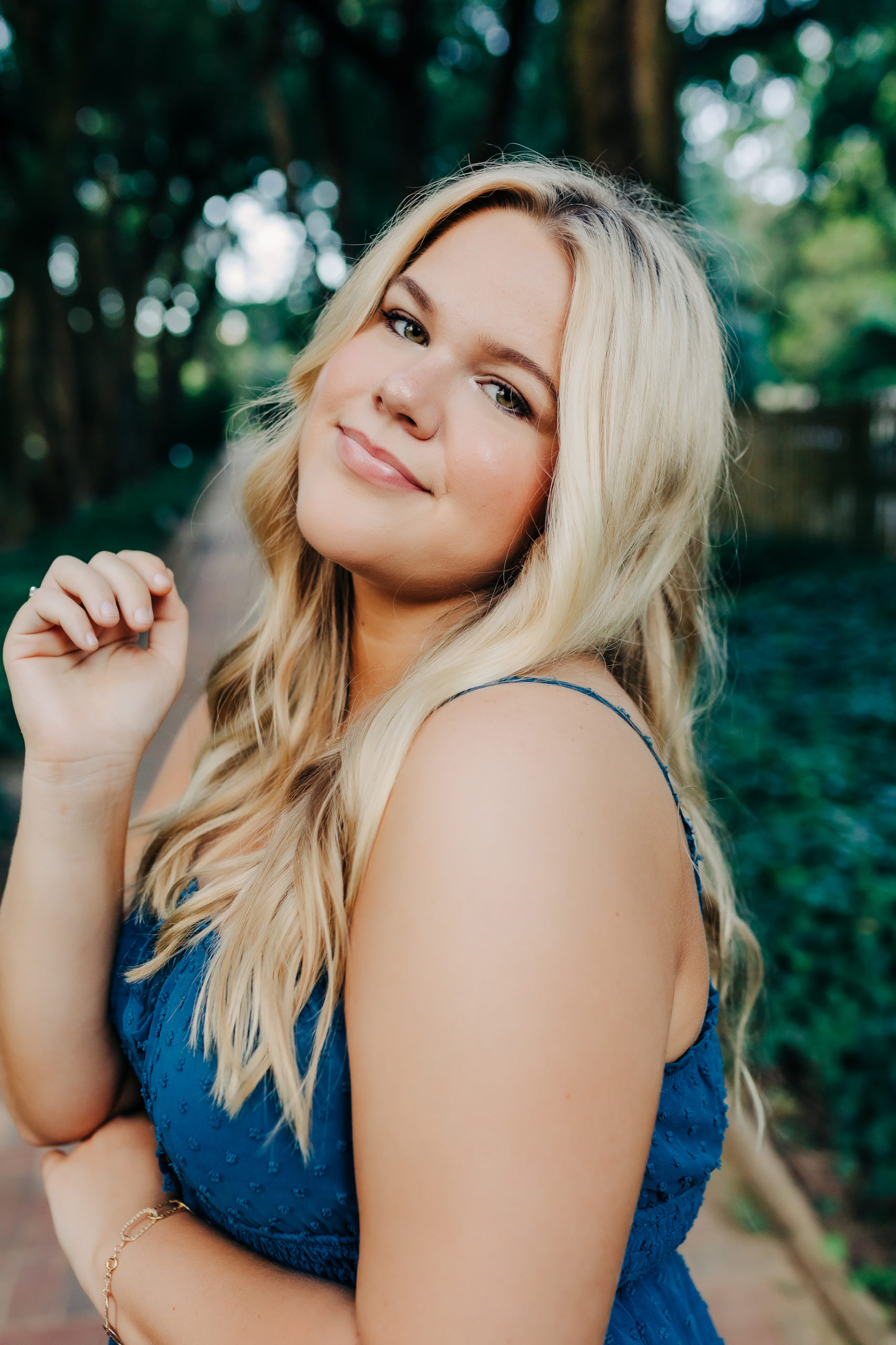 outdoor senior portraits with blonde girl in blue dress 