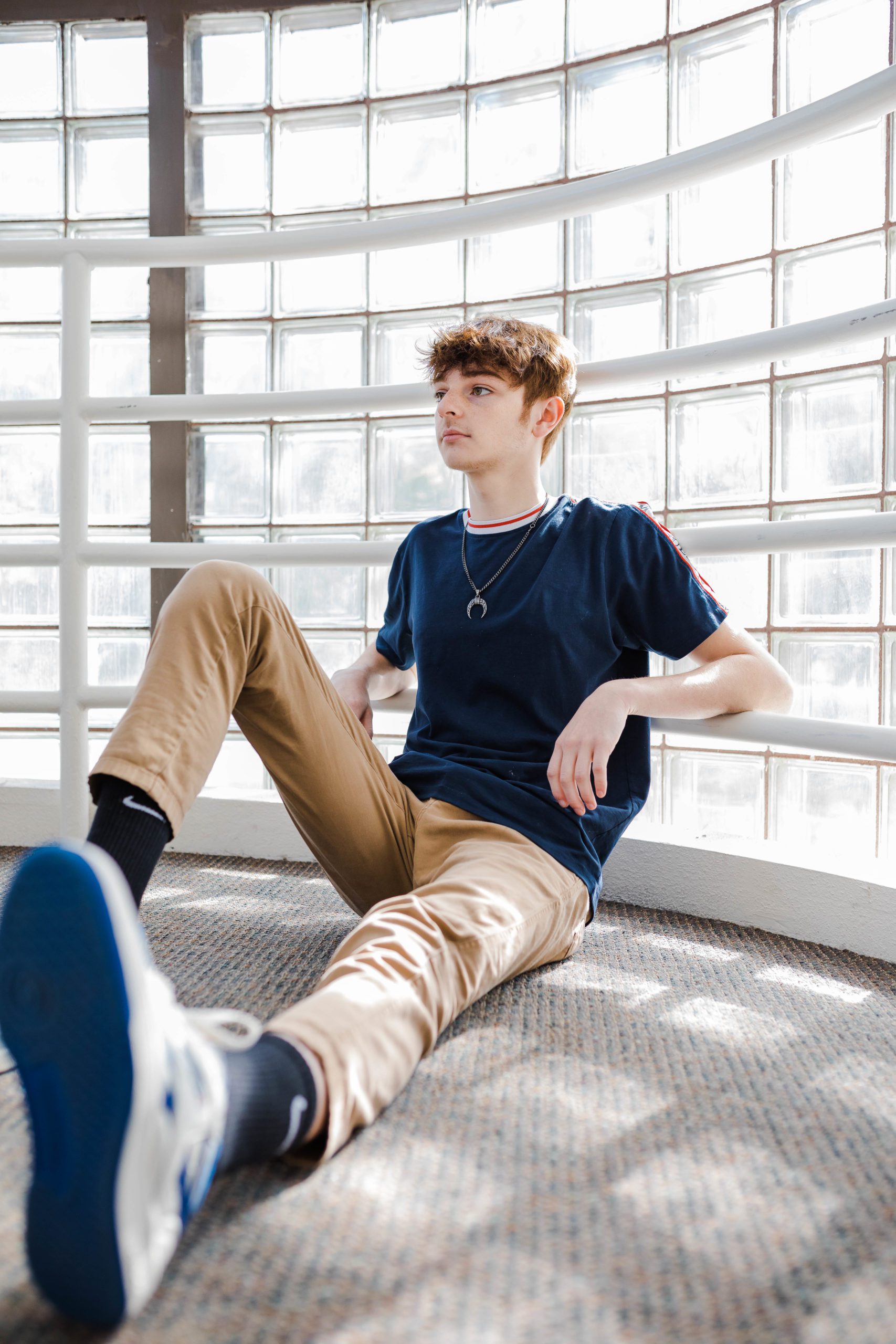 young man sitting on the floor of a cool window room in Augusta 