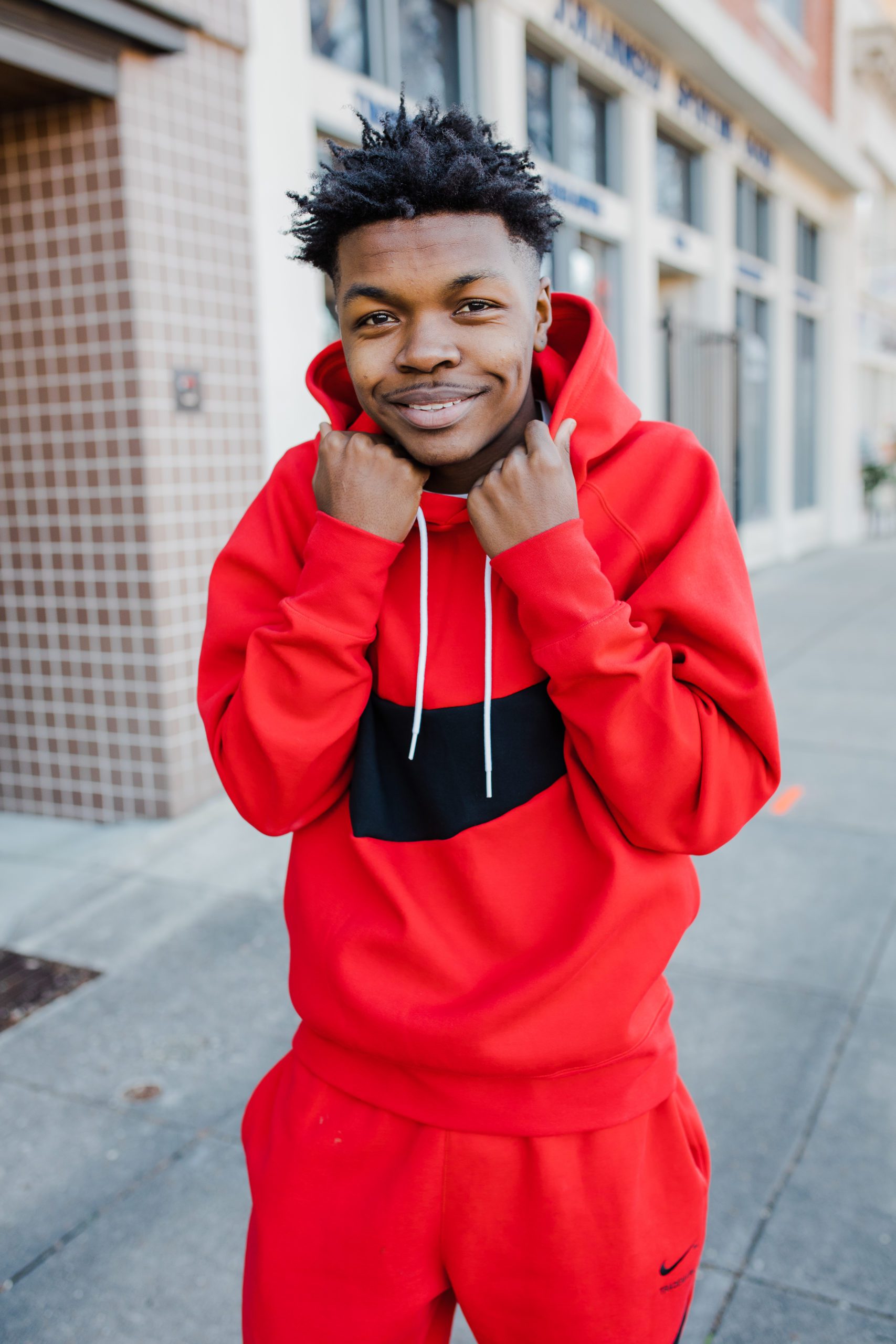 senior photos of young man in a red nike sweatshirt take by Augusta photographer